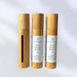 three mood booster essential oil rollers on white background