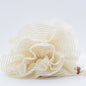 a beige shower loofah on display on white surface