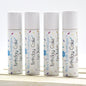 Four small tubes of Birthday Cake flavor lip balm standing in a row