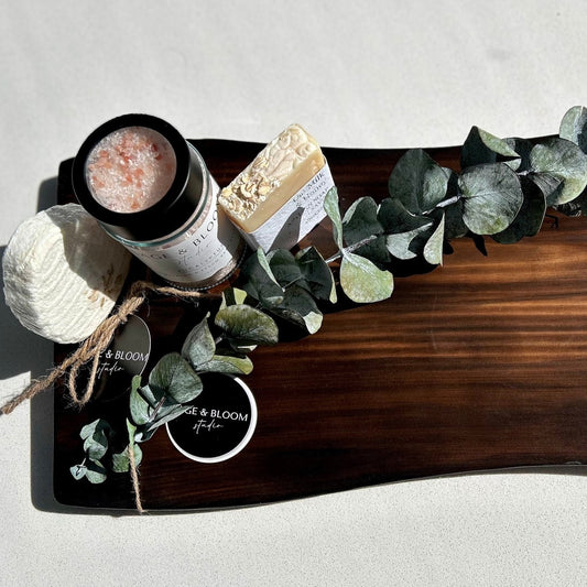 a wood bath caddy with bath and body products and eucalyptus stem