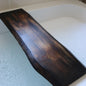 a wood bath caddy is displayed over a bathtub filled with bubble water