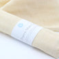 organic muslin cloth rolled up inside a Bee Clean Boutique lable