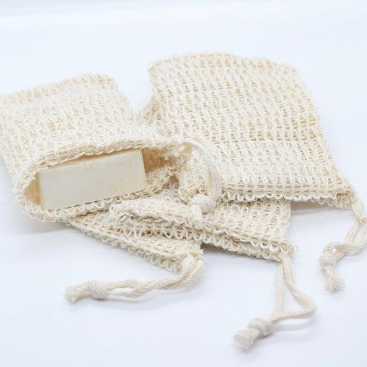 sisal soap pouches, one with a bar of soap peeking out, displayed on a white surface