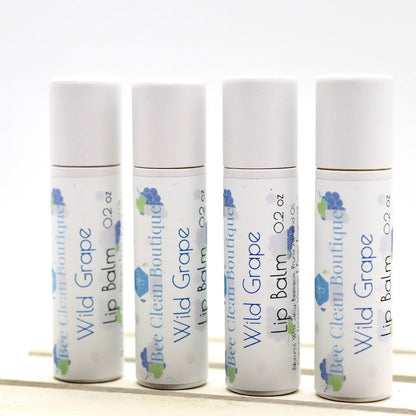 Four tubes of Wild Grape lip balm standing in a row